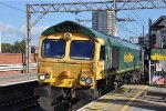 Inbound intermodal trails a Class 66 through the station